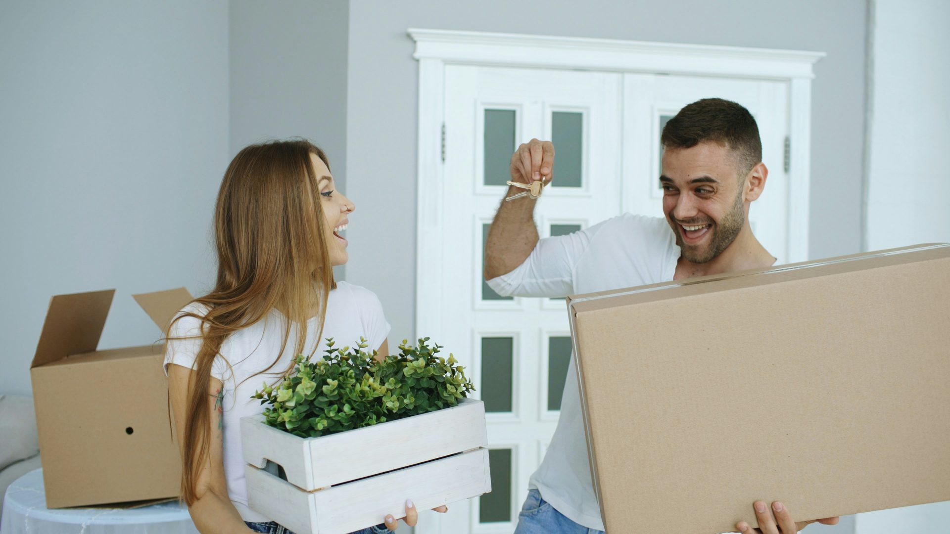 Happy couple with keys to their new home